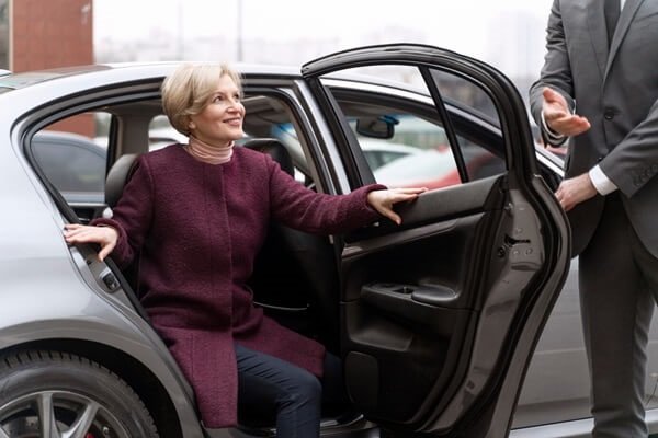 Private Chauffeur in Zermatt opening the vehicle door 